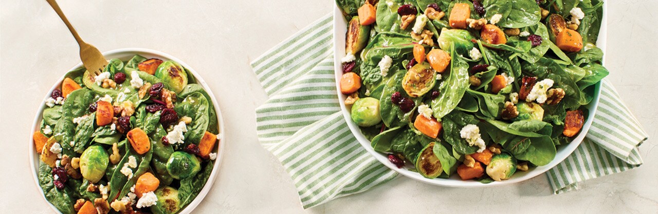 Fall-inspired salad with power greens, sweet potatoes, brussels sprouts, walnuts, dried cranberries and crumbled feta.