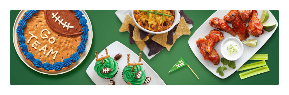 Game Day Party Spread including a cookie pizza, bean dip, buffalo wings, and football themed cupcakes.
