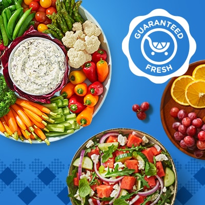 Fresh veggie tray with snackable peppers, cauliflower, asparagus, grape tomatoes, snap peas, broccoli and carrots. A summery salad with arugula, red onion, watermelon, cucumber and feta cheese crumbles.