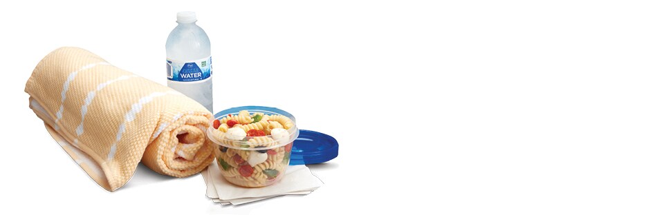 pool towel, bottle water and bowl of pasta salad