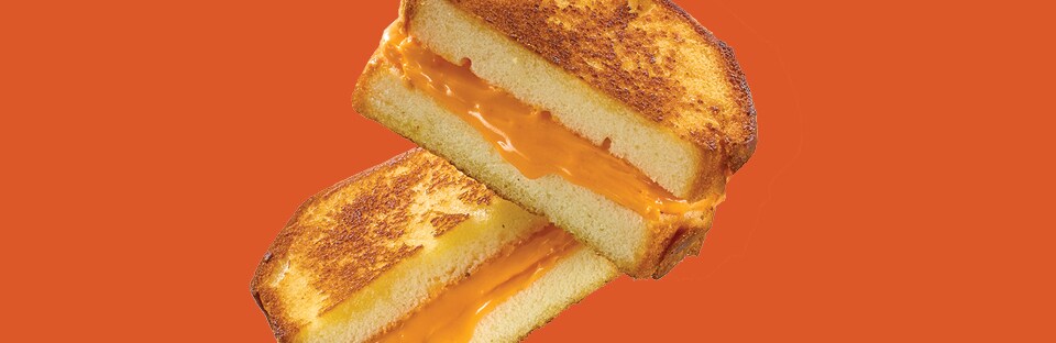 Bread with gold icing in the middle that looks like a grilled cheese sandwich