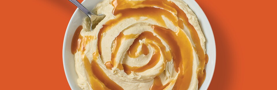 smashed cheesecake topped with cara-mel sauce that looks like mashed potatoes and gravy