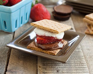 Jelly filled smore on silver plate on a wooden table