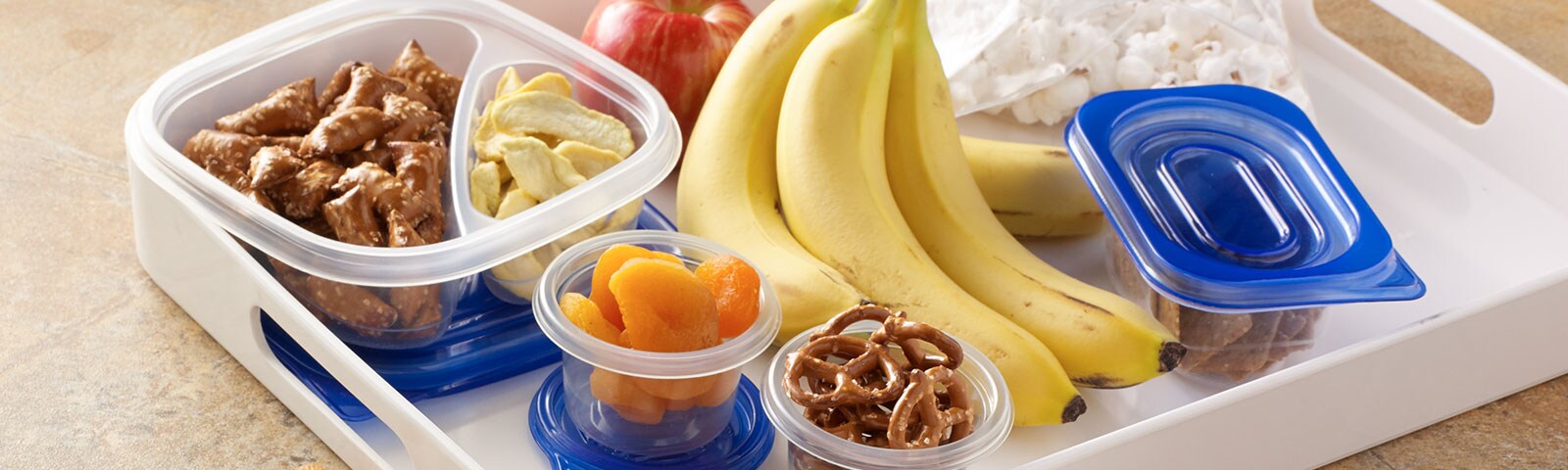 Containers of snacks on a white tray