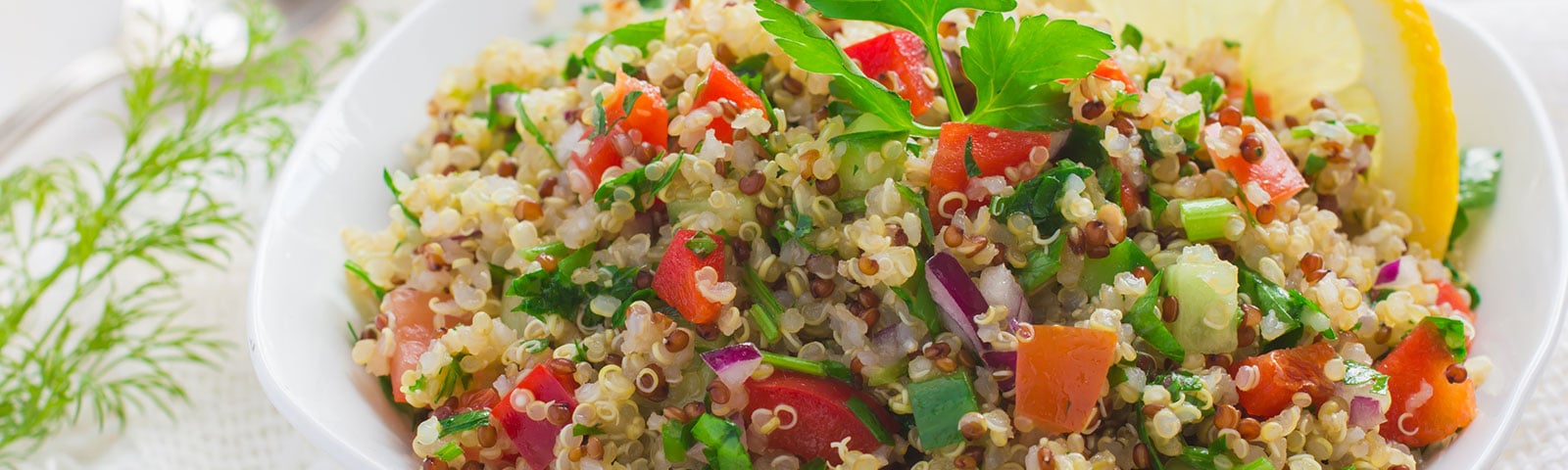 Bowl of cooked quinoa, tomatoes and onion