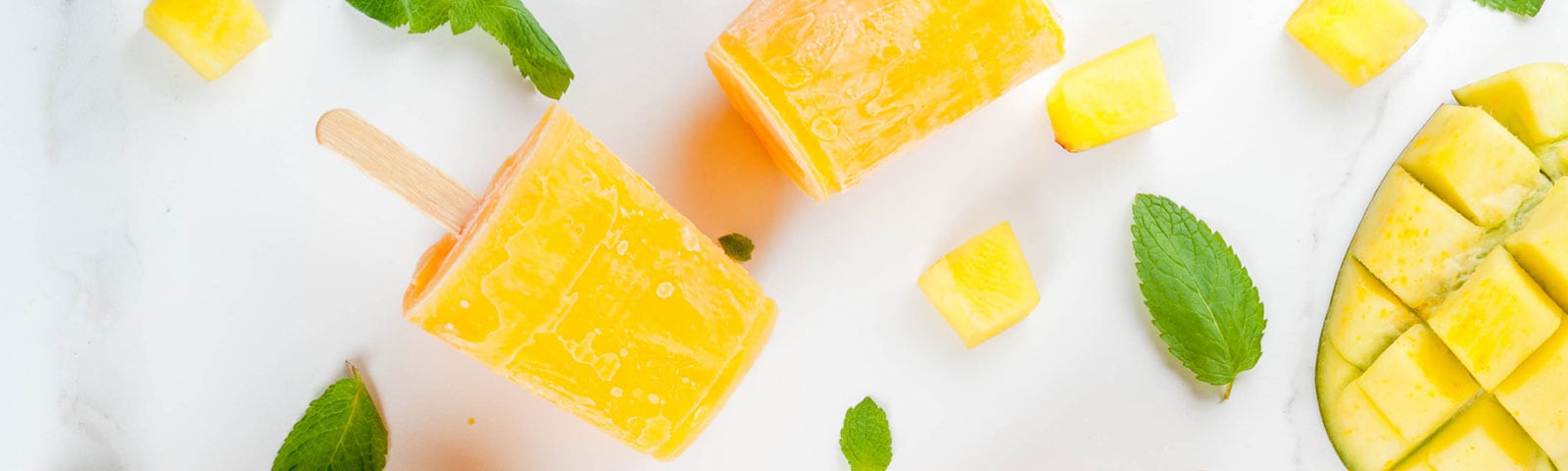 Cut up fruit freezed into popsicles on a stick