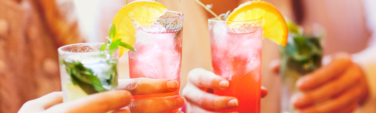 People in a group holding their mixed drinks
