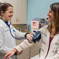 A clinician taking a patient’s blood pressure A clinician taking a patient’s blood pressure