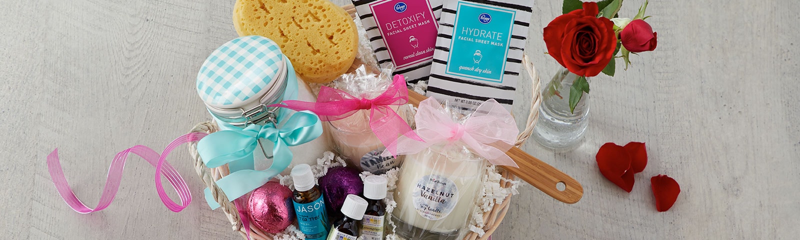 Gift basket filled with valentine's date checklist items such as candles, bath bombs and face masks