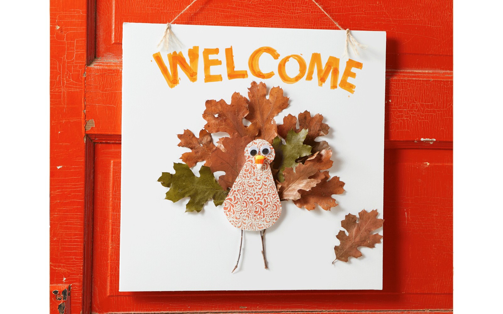 Turkey made out of paper for Thanksgiving and hung on red door