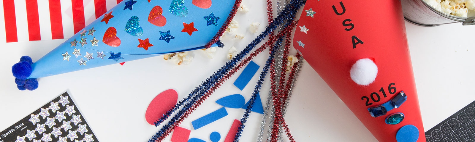 Patriotic cones with decorations like stickers, glitter and pom poms