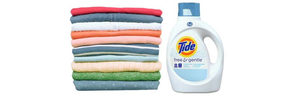 a stack of folded laundry and a bottle of laundry detergent
