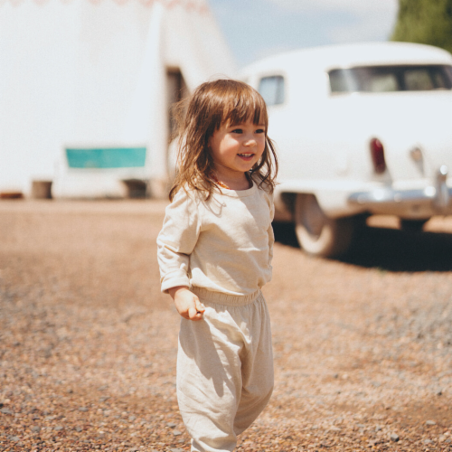 Organic Neutral Long Sleeve Bodysuit in Natural Undyed Cotton - Natural Perspective: bottom