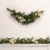 Northlight 6' x 9 Poinsettia and Pinecone Artificial Christmas Garland, Unlit Perspective: back
