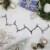 Northlight 50ct Purple LED Mini Christmas Lights, 16.25ft Green Wire Perspective: back