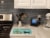 Black and Tan Chion Christmas Tree Glass Cutting Board Large Perspective: back