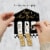 Big Dot of Happiness New Year’s Eve Gold Party Game Pickle Cards Pull Tabs 3-in-a-Row 12 Ct Perspective: back