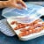 Nordic Ware® Microwave Slanted with Lid Bacon Tray Perspective: left