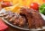 Curly's Hickory Smoked & Seasoned Baby Back Pork Ribs with Barbecue Sauce Perspective: left