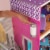 KidKraft Uptown Wooden Dollhouse Mansion with Modern Furniture Set, Pink Perspective: left