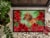 Carolines Treasures CK1300MAT Dachshund Poinsettas Doormat 18x27 Perspective: top